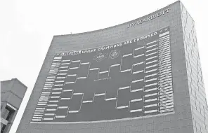  ?? BARBARA J. PERENIC/ USA TODAY SPORTS ?? Filling out an NCAA Tournament bracket has become a tradition in many offices.