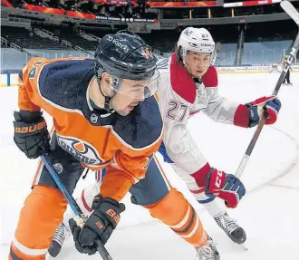  ?? GREG SOUTHAM/POSTMEDIA ?? Edmonton Oilers’ forward Devin Shore and Montreal Canadiens’ defenceman Alexander Romanov battle at Rogers Place in Edmonton on Saturday night.