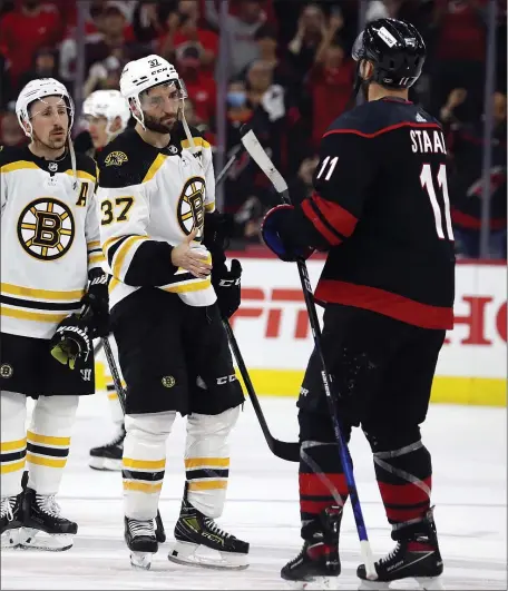  ?? AP ?? MAYBE A LAST HURRAH: Patrice Bergeron waits in line to shake hands with Carolina’s Jordan Staal and the rest of the Hurricanes following the Bruins’ 3-2 loss in Game 7 on Saturday.