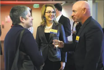  ?? Scott Strazzante / The Chronicle ?? Ex-Rep. Gabby Giffords (center) and husband Mark Kelly chat with University of California President Janet Napolitano at a fundraiser for a scholarshi­p in memory of her slain aide.