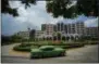  ??  ?? A vintage car passes in front of the Four Points by Sheraton hotel in Havana, Cuba.