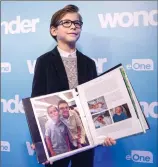  ?? THE CANADIAN PRESS/CHRIS YOUNG ?? Jacob Tremblay, star of the movie "Wonder" holds a binder, containing letters written to him to help him prepare for his role, as he attends attends an event at Toronto's Sick Kids Hospital, in Toronto on Monday.