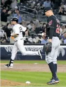  ?? BILL KOSTROUN/THE ASSOCIATED PRESS ?? Indians pitcher Corey Kluber, right, reacts as the Yankees’ Chase Headley rounds the bases Monday after hitting a home run to end Cleveland’s shutout streak. The Indians won, 6-2.