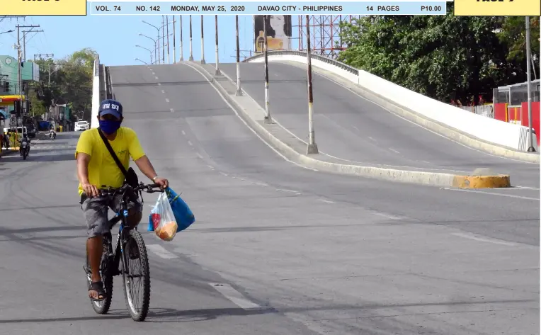  ?? BING GONZALES ?? A MAN bikes past the flyover on his way home from the wet market. The city government recently closed down the Agdao Public Market and enrolled vendors under the ameliorati­on program.