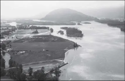  ?? CP PHOTO ?? The swollen Fraser River is seen in an aerial view in Chilliwack, B.C., on May 16. Any people forced from their homes by flooding in southern British Columbia have been allowed to return, but officials say there are still areas of concern in many parts...