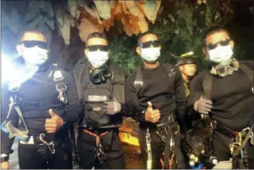  ?? ROYAL THAI NAVY VIA AP ?? In this undated photo released by Royal Thai Navy on Tuesday show the last four Thai Navy SEALs come out safely after completing the rescued mission inside a cave where 12 boys and their soccer coach have been trapped since June 23, in Mae Sai, Chiang...