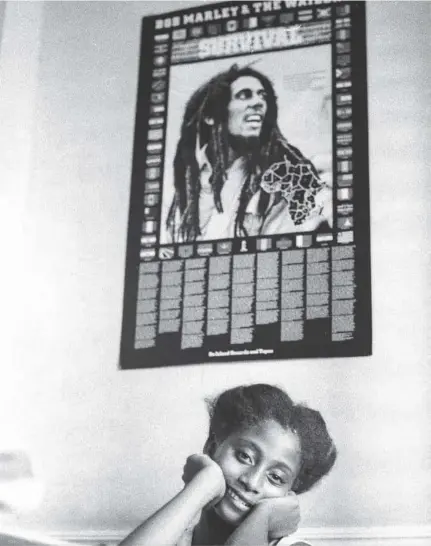  ??  ?? A young Nadine Sutherland rests beneath a poster of Bob Marley.