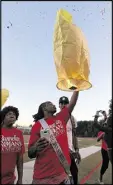  ?? CURTIS COMPTON PHOTOS / AJC ?? Jerrell Mumford, brother of Jerrett and Jaylen Mumford, releases a balloon at the memorial.