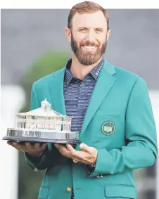  ?? — AFP photo ?? Dustin Johnson poses with the Masters Trophy during the Green Jacket Ceremony after winning the Masters at Augusta National Golf Club in Augusta, Georgia.