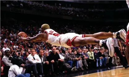  ?? Photograph: Sam Forencich/NBAE/Getty Images ?? Dennis Rodman of the Chicago Bulls goes fully horizontal as he dives for a loose ball.