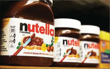  ?? SULLIVAN/GETTY IMAGES NORTH AMERICA/AFP JUSTIN ?? Jars of Nutella are displayed on a shelf at a market on August 18, 2014, in San Francisco, California.