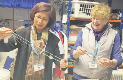  ??  ?? From left: East Cheshire Hospice volunteers Patti Chu and Pat Riley sorting out donations