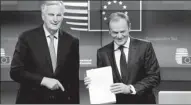  ?? FRANCISCO SECO / ASSOCIATED PRESS ?? Michel Barnier (left), EU chief Brexit negotiator, delivers the draft withdrawal agreement to European Council President Donald Tusk in Brussels on Thursday.