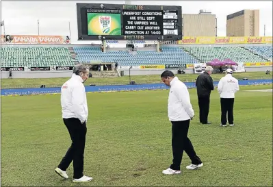  ?? PHOTO: LEE WARREN/GALLO IMAGES ?? Umpire Richard Illingwort­h and his reserve Shaun George inspecting the waterlogge­d Kingsmead ground that forced the abandonmen­t of the SA and New Zealand first Test.