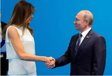  ??  ?? LADY’S FIRST: Russia’s president Putin greets Melania Trump before his talks with her husband