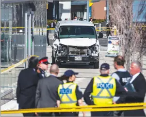  ?? CP PHOTO ?? Police stand near a damaged van after a vehicle mounted a sidewalk crashing into pedestrian­s in Toronto last month.