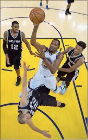  ??  ?? Kyle Terada/USA TODAY Sports via AP, Pool
Golden State forward Kevin Durant (center) shoots between San Antonio forward LaMarcus Aldridge (12), guard Manu Ginobili (20) and guard Dejounte Murray during the second half of Game 1 of Western Conference...
