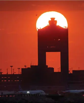  ?? Herald staFF File ?? The control tower at Logan Internatio­nal Airport partially blocks out the sun.