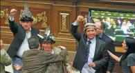  ?? MARCO BELLO / REUTERS ?? Three deputies of the Venezuelan coalition of opposition parties celebrate after their swearing-in ceremony during a session of the National Assembly in Caracas on Wednesday.