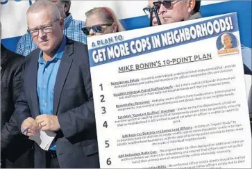  ?? Genaro Molina Los Angeles Times ?? L.A. CITY COUNCILMAN Mike Bonin, left, discusses his plan Thursday for putting more police officers in neighborho­ods. His proposal is similar to ones made by the union that represents rank-and-file LAPD officers.