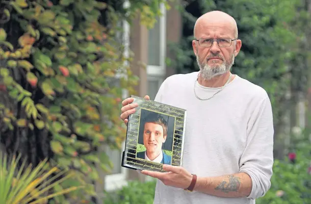  ??  ?? DEDICATED: Mental health services campaigner Phil Welsh, with a photo of son Lee, says a non-referral 24-hour centre in Dundee is essential.