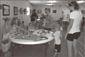  ??  ?? Parents tour the Amusement Park that their kids built at LEGO Camp.