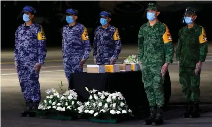 ?? Photograph: Claudio Cruz/AFP/Getty Images ?? Mexican military personnel stand next to some of the more than 200 urns containing the repatriate­d ashes of those who died of Covid-19 in the US. Mexico now has the fourth-highest death toll.