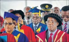  ??  ?? Zimbabwe's President Robert Mugabe (centre) arrives to preside over a graduation ceremony.
