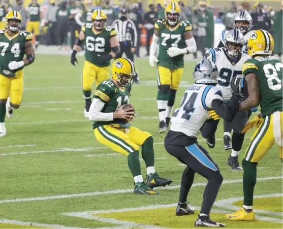  ?? GETTY IMAGES ?? Aaron Rodgers scores on a six- yard run in the second quarter. Rodgers also threw for a touchdown in the first quarter to reach 40 for an NFL- record third season.