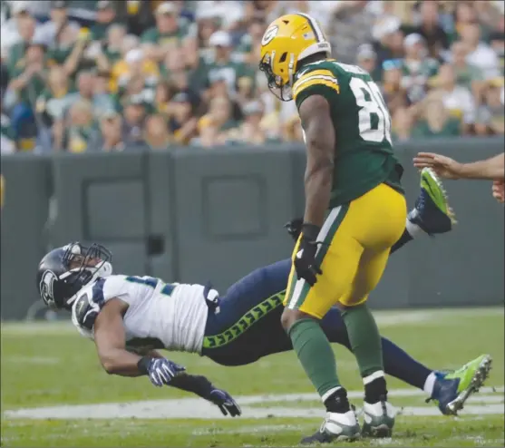  ?? The Associated Press ?? Martellus Bennett of the Green Bay Packers, right, is called for a personal foul for hitting K.J. Wright of the Seattle Seahawks after a play during their NFL season-opener on Sunday in Green Bay, Wis. The Packers won 17-9.