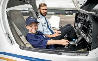  ?? DAVID UNWIN/STUFF ?? Manawatu¯ child Domanic Grant and Massey University school of aviation pilot Reuben Wohlers after flying to Hawke’s Bay as part of a fundraiser.