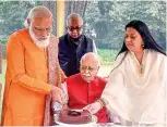  ??  ?? Narendra Modi with senior BJP leader LK Advani in New Delhi on latter’s 93rd birthday on Sunday