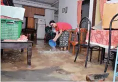  ??  ?? Suria Mohd Sahmi, 47, stands in ankle-deep water at her home in Kampung Sementa, Kapar in Klang, which was flooded due to the high tide phenomenon.