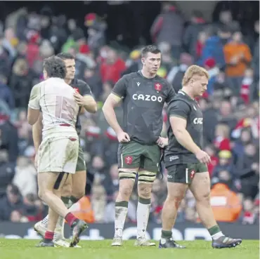  ?? ?? ↑ Wales players show their dejection after losing 13-12 to Georgia in Cardiff on Saturday