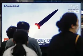  ?? AHN YOUNG-JOON/ASSOCIATED PRESS ?? At the Suseo Railway Station in Seoul, South Korea, people watch a TV news program Thursday about North Korea’s missile launch. The rogue nation test-fired its first ballistic missiles since President Joe Biden took office.