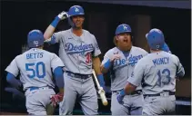  ?? TONY GUTIERREZ — THE ASSOCIATED PRESS ?? Los Angeles Dodgers’ Max Muncy celebrates his grand slam during the first inning in Game 3 of the NLCS against the Atlanta Braves on Wednesday.