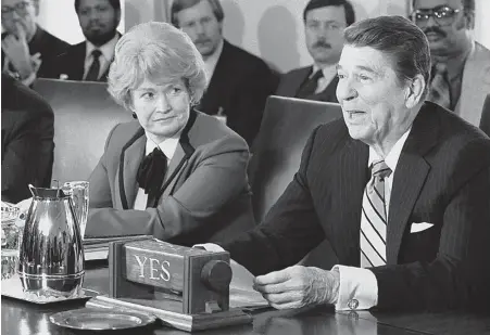  ?? AP FILE PHOTOS ?? CABINET POST: Health and Human Services Secretary Margaret Heckler is seen with President Ronald Reagan in 1985 at a meeting about missing children.