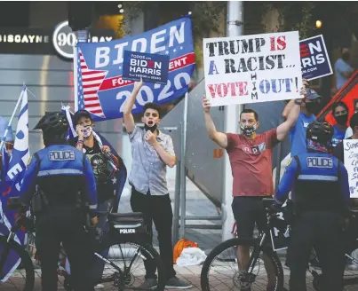  ?? MARCO BELLO/ REUTERS ?? Supporters of Democratic presidenti­al nominee Joe Biden gather outside Perez Art Museum before the arrival of U.S. President Donald Trump for a town hall in Miami on Thursday.