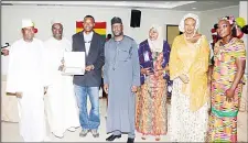  ??  ?? Abubakar (third left), shows off his plaque of appreciati­on flanked by AGRIK
officials.