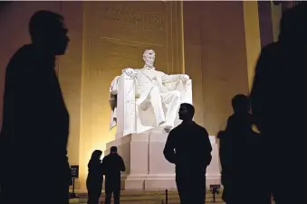  ?? ANDREW HARRER/BLOOMBERG ?? Nighttime visitors view the statue of President Abraham Lincoln at the Lincoln Memorial on Feb. 27, 2018, in Washington, D.C.