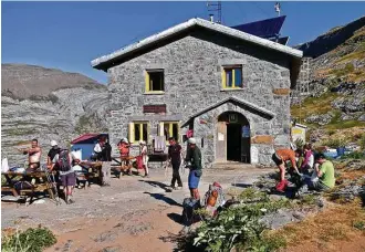  ??  ?? Guests at the Refugio de Góriz in the Ordesa and Monte Perdido National Park lather on sunscreen and get ready to head out for the day.