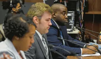  ?? KIM HAIRSTON/BALTIMORE SUN ?? Commission­ers Maya Davis, from left, of the Maryland Commission of African American History and Culture; David Armenti, of the Maryland Center for History and Culture; and Vice Chair Charles Chavis Jr., of George Mason University, listen during a Maryland Lynching Truth and Reconcilia­tion Commission public hearing in the Baltimore County Council Chambers.