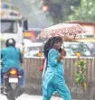  ?? EMMANUAL YOGINI ?? A woman walking in heavy rain after the dust storm in Mumbai on Monday.