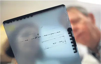  ??  ?? Marc Van Grieken and Dr Esther Sammler, consultant neurologis­t at Ninewells and honorary senior clinical lecturer at Dundee University, studying a Western Blot, which relates to Parkinson’s.