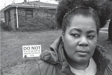  ?? Associated Press ?? n Tara Adams poses for a portrait Thursday outside her home as she tries to organize a move from the East Chicago, Ind., dwelling. Adams is one of dozens of families remaining at a lead-contaminat­ed public housing complex in northwest Indiana, despite...