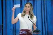  ?? (AP Photo/michael Wyke/file) ?? Lara Trump, the newly-elected co-chair of the Republican National Committee, holds up a donation check on March 8 as she gives an address during the general session of the RNC Spring Meeting in Houston. “My number one goal is making sure that Donald Trump is the 47th president,” Trump said in an interview with The Associated Press.