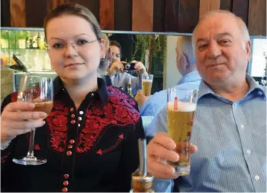  ??  ?? Victims: Sergei Skripal and his daughter Yulia pictured in Zizzi restaurant in Salisbury in 2016