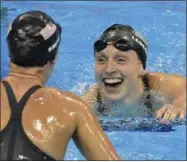  ?? MARTINMEIS­SNER — THE ASSOCIATED PRESS ?? United States’ Katie Ledecky, right, celebrates with United States’ Leah Smith after setting a new world record in the women’s 400-meter freestyle final during the swimming competitio­ns at the Summer Olympics Sunday in Rio de Janeiro, Brazil.