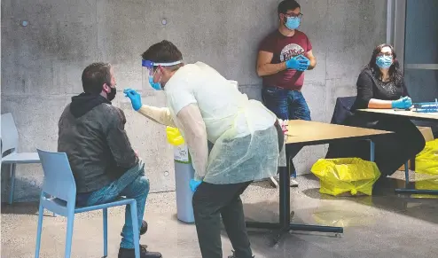  ?? ANDREW VAUGHAN / THE CANADIAN PRESS FILES ?? A swab is taken at a pop-up COVID-19 testing site on the Dalhousie University campus in Halifax in November. The volunteer-operated effort was intended to be a proactive push to find the virus where it might be circulatin­g undetected, and to get community buy-in for staying vigilant.