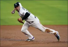  ?? DAVID ZALUBOWSKI - THE ASSOCIATED PRESS ?? FILE - In this Sept. 11, 2020, file photo, Colorado Rockies third baseman Nolan Arenado throws to first during the first inning of a baseball game against the Los Angeles Angels in Denver.